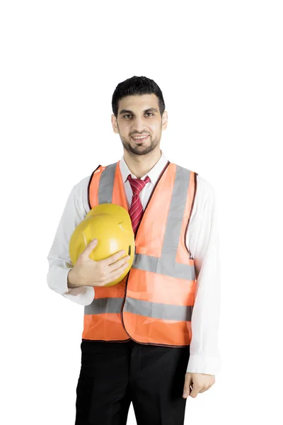 Young engineer holding his helmet on studio — Stock Photo, Image