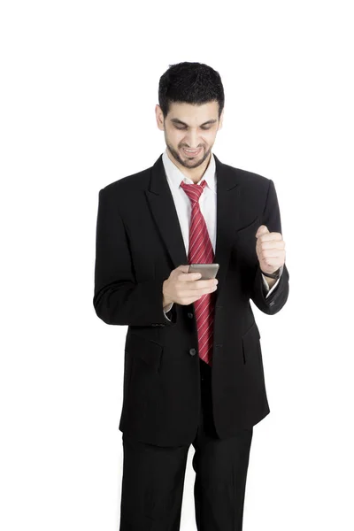 Successful businessman with a smartphone on studio — Stock Photo, Image