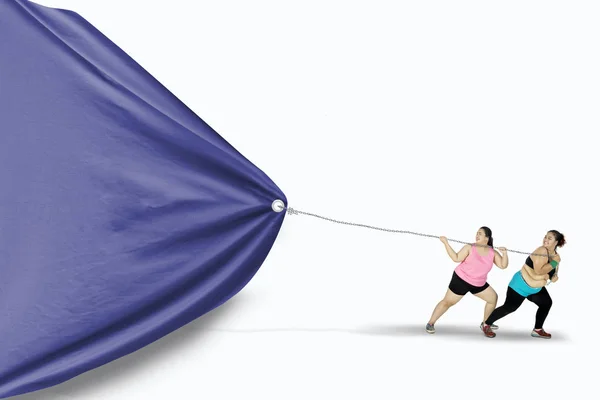 Mujeres con sobrepeso tirando de banner vacío — Foto de Stock