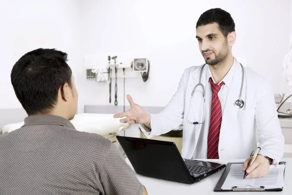 Italian doctor writing prescription for his patient — Stock Photo, Image