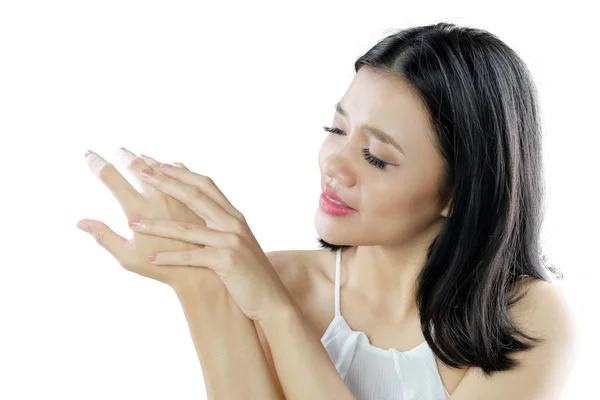 Beautiful woman applying body cream on her arm — Stock Photo, Image