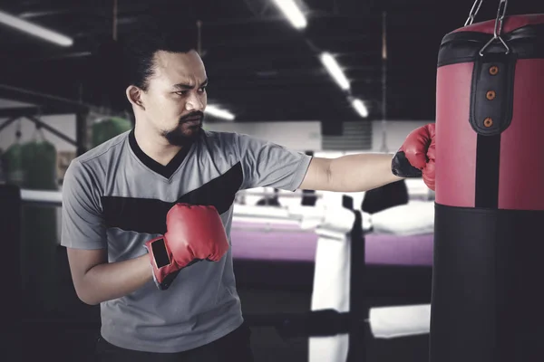 Afro man exercise with boxing sack — Stock Photo, Image