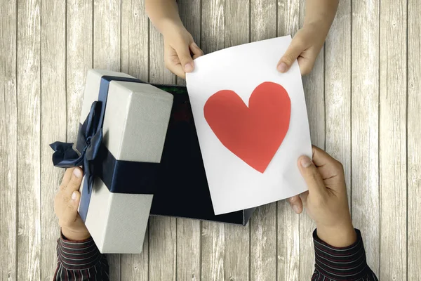 Niño da tarjeta de felicitación y caja de regalo — Foto de Stock