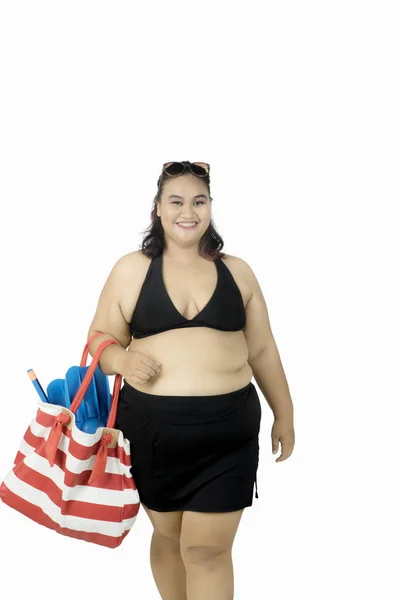 Fat woman carrying snorkeling equipment — Stock Photo, Image