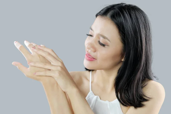 Woman applying body cream on her arm — Stock Photo, Image
