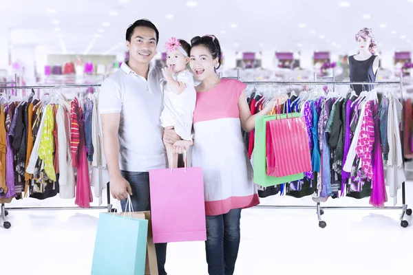 Happy family smiling in clothing store — Stock Photo, Image