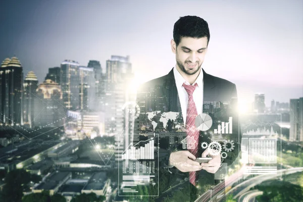 Businessman with skyscraper in the background — Stock Photo, Image