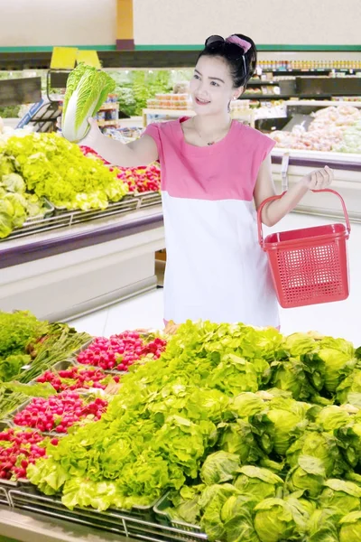 Jolie femme choisissant un légume frais — Photo