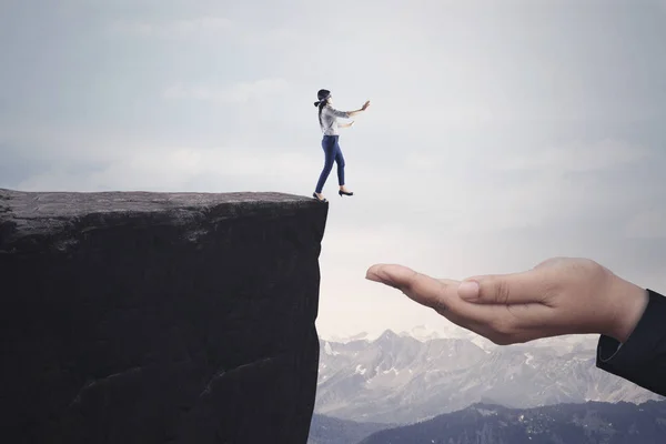 Businesswoman walks toward a helping hand — Stock Photo, Image