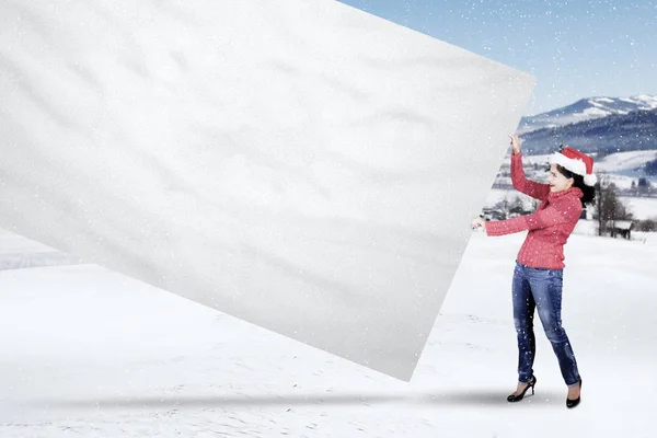 Donna con cappello Babbo Natale tira banner vuoto — Foto Stock