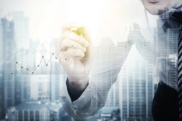 Unknown businessman with finance graph and skyscraper — Stock Photo, Image