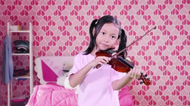 Meisje spelen viool in slaapkamer — Stockvideo