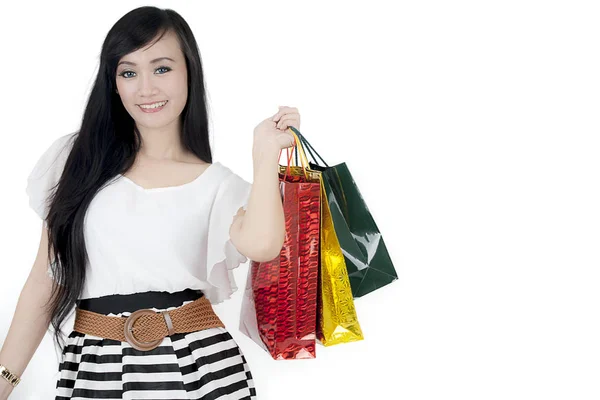 Beautiful woman holding shopping bags on studio — Stock Photo, Image