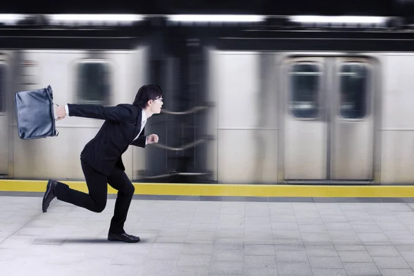 Asian businessman rushing for a train — Stock Photo, Image