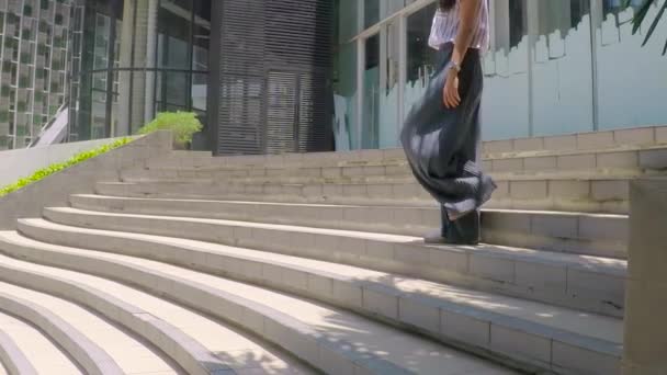 Businesswoman with cellphone on stair — Stock Video