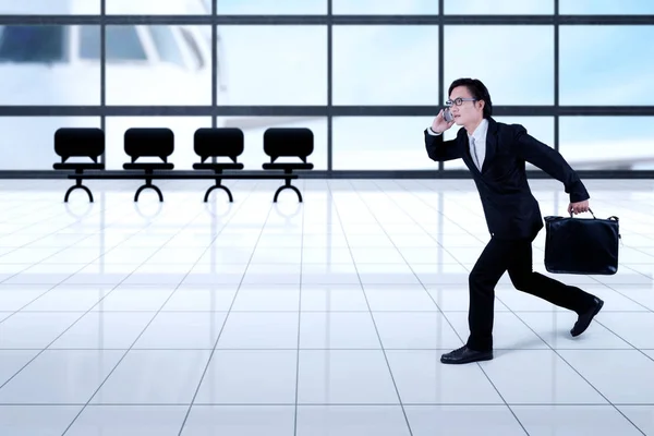 Empresário asiático correndo no aeroporto — Fotografia de Stock