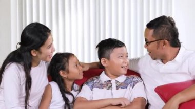 Mutlu aile oturma odasında sohbet ve birlikte evde kanepede gülüyor süre having fun