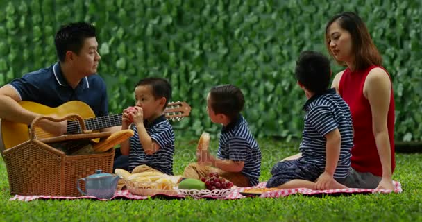 Glückliche Familie Beim Gemeinsamen Gitarrespielen Und Singen Beim Picknick Park — Stockvideo