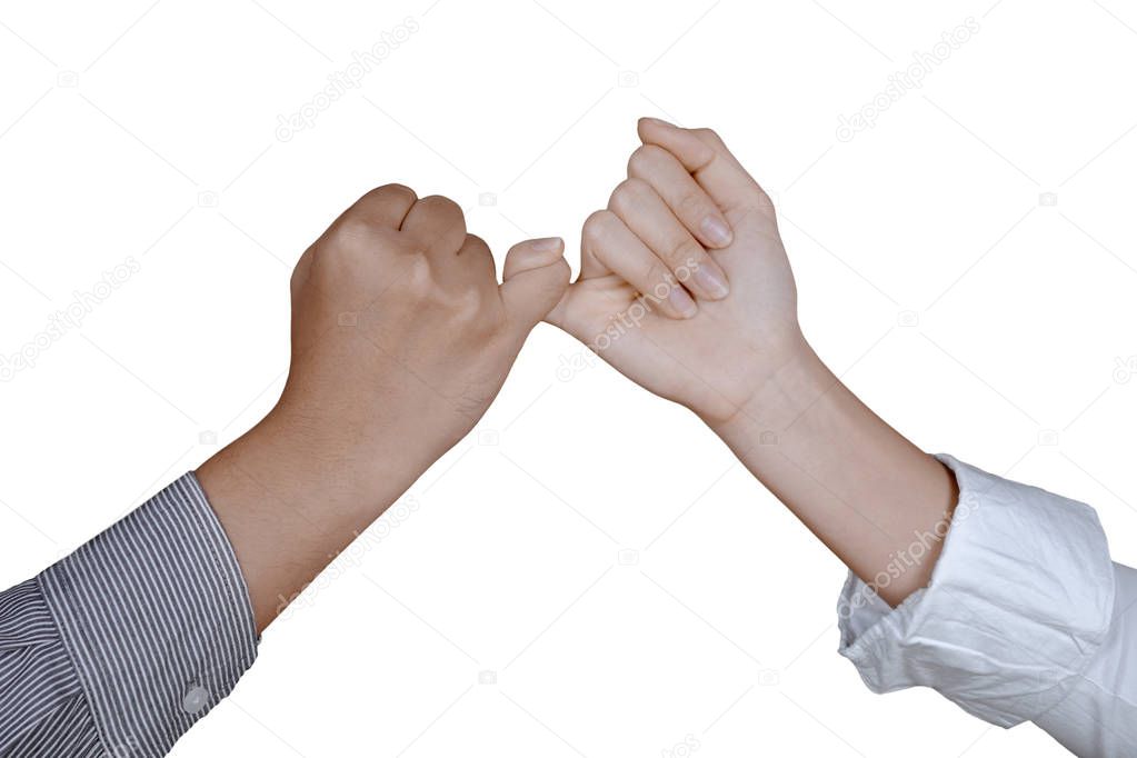 Two business people making a pinkie promise