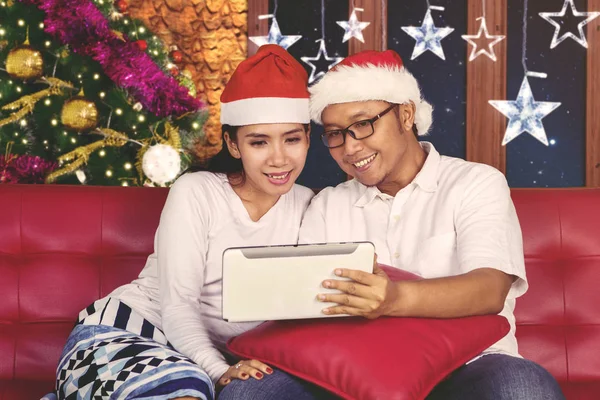 Casal asiático usando tablet na época do Natal — Fotografia de Stock