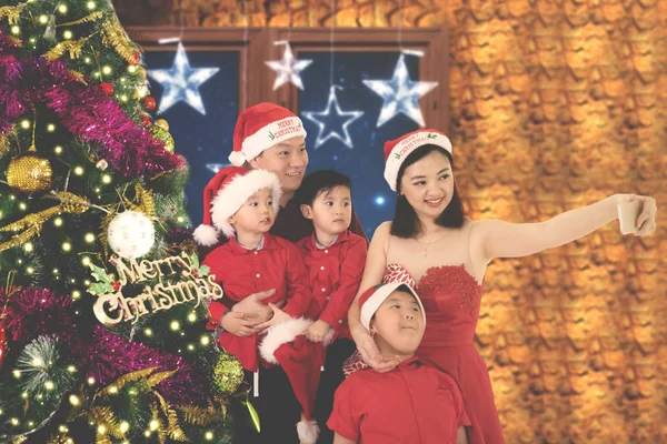 Família feliz tira foto com árvore de Natal — Fotografia de Stock