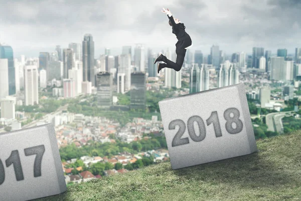 European businessman jumping to number 2018 — Stock Photo, Image