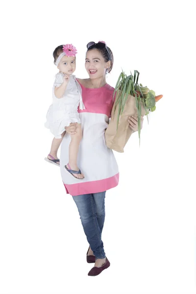 Mujer joven con niño y bolsa de compras — Foto de Stock