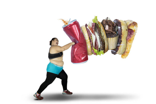Obese woman punching unhealthy food