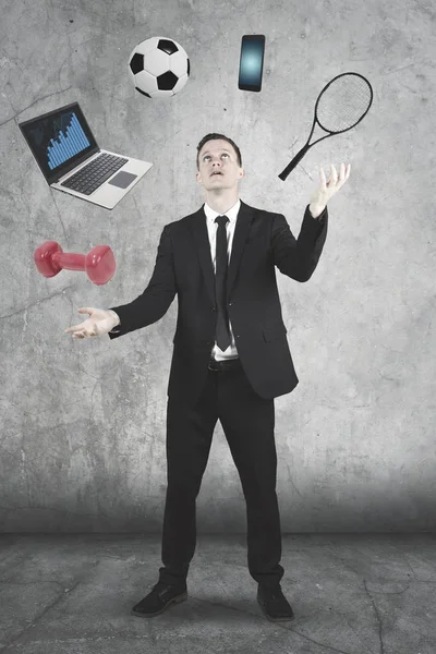 European businessman juggling with many objects — Stock Photo, Image