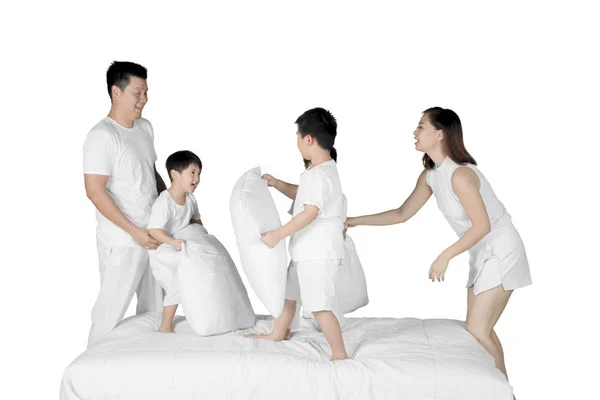 Asian family having fun with pillows on studio — Stock Photo, Image
