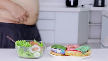 Diyet kavramı. Seçme meçhul kilolu adam ve bir kase salata çörek daha al. 4 k çözünürlükte vurdu