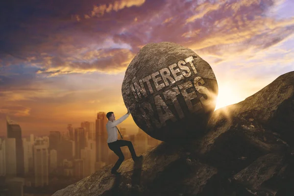 European businessman pushing text of interest rates — Stock Photo, Image