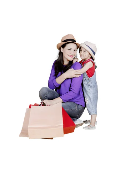 Criança e mãe com sacos de compras no estúdio — Fotografia de Stock