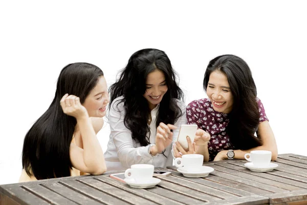 Drei glückliche Frauen mit einem Handy — Stockfoto