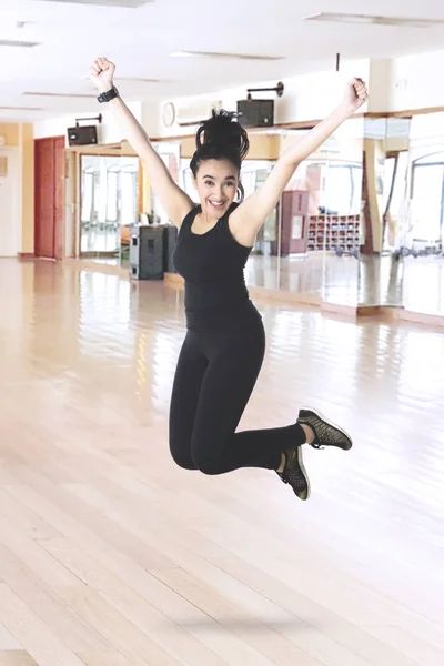 Aufgeregte Frau springt im Fitnessstudio — Stockfoto