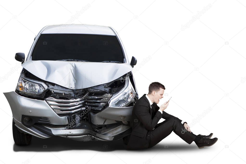 Angry businessman with broken car