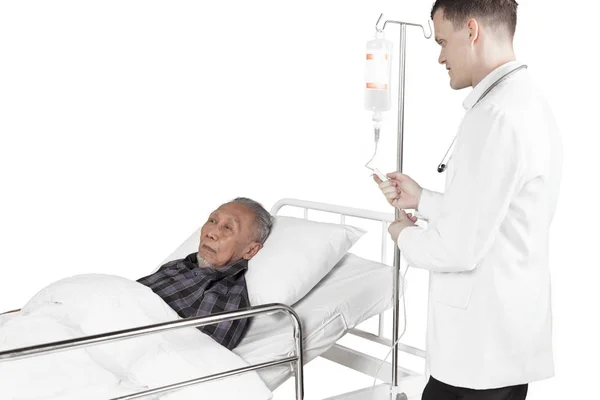 European doctor adjusting infusion on studio — Stock Photo, Image