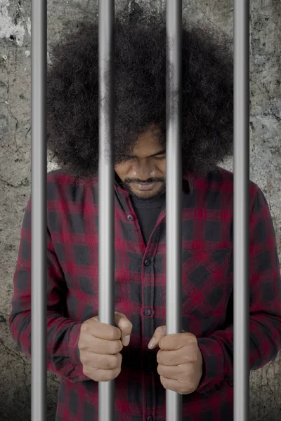 Afro man looks desperate in the jail — Stock Photo, Image