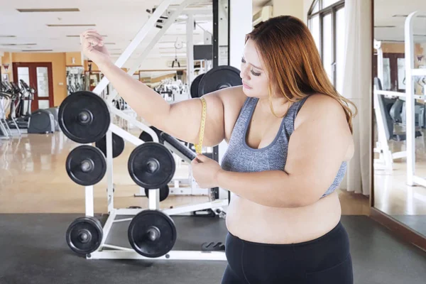 Femme obèse caucasienne mesurant son biceps — Photo