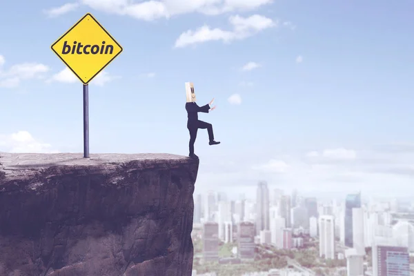 Unknown businessman with bitcoin word on cliff — Stock Photo, Image