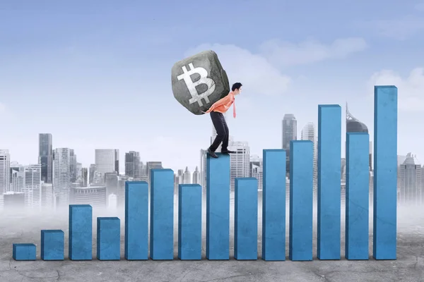 Männlicher Unternehmer hebt Symbol für Bitcoin — Stockfoto