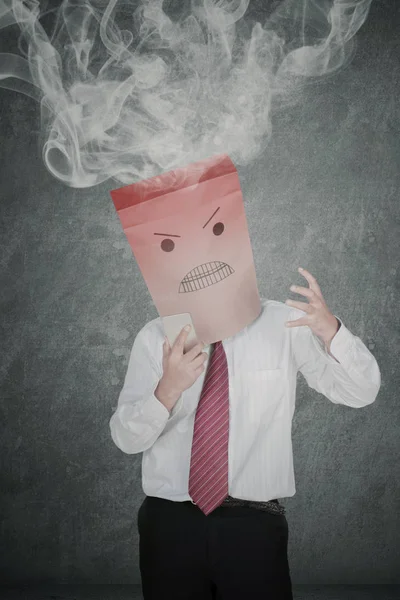 Anonymous businessman with smoke over his head — Stock Photo, Image