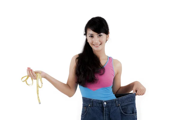 Proud asian woman showing her weight loss — Stock Photo, Image