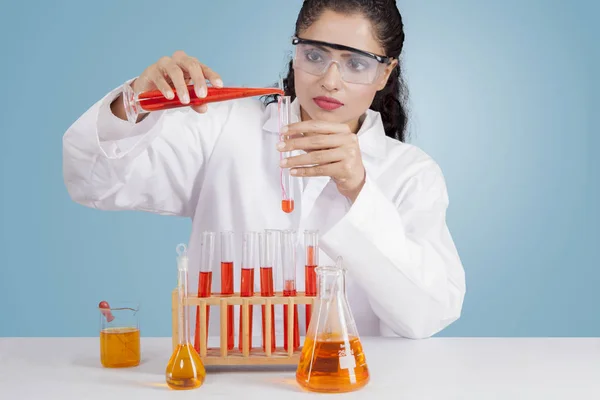 Hermosa mujer india mezclando productos químicos — Foto de Stock