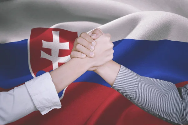 Hands of business people with Slovakia flag — Stock Photo, Image