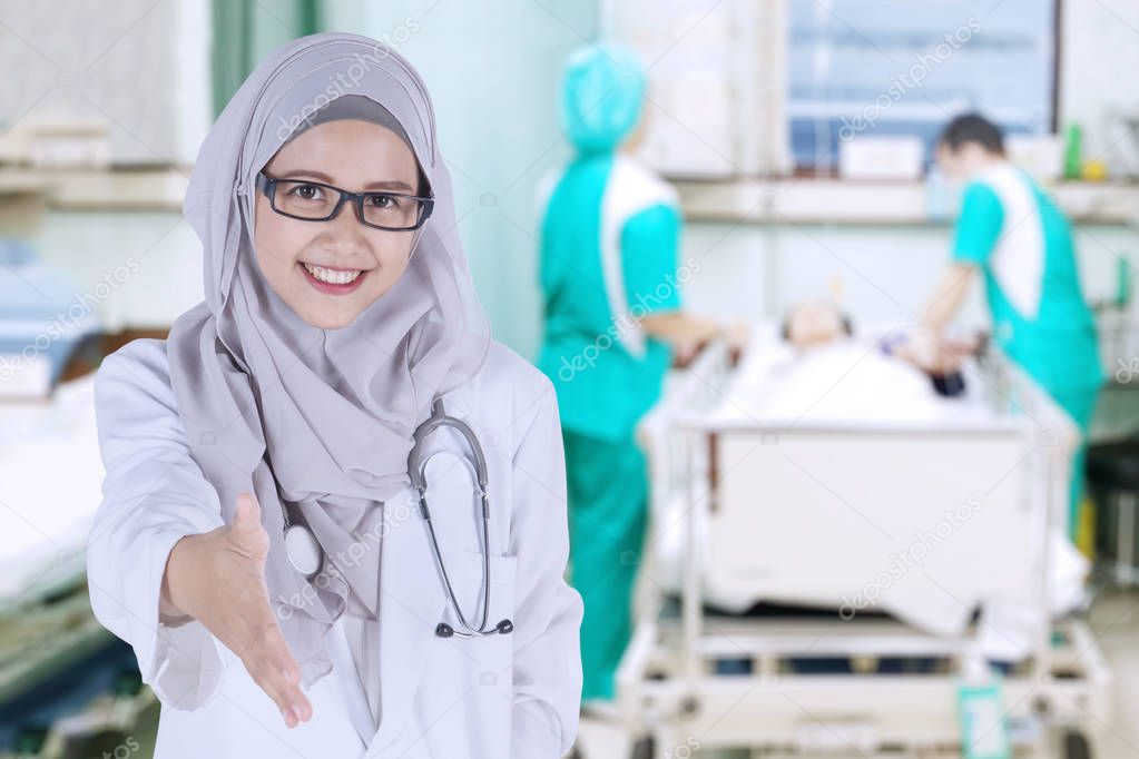 Muslim doctor offering handshake in the hospital