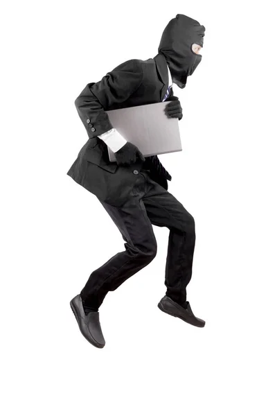 Thief dressed in black and wearing a balaclava stealing a laptop computer — Stock Photo, Image