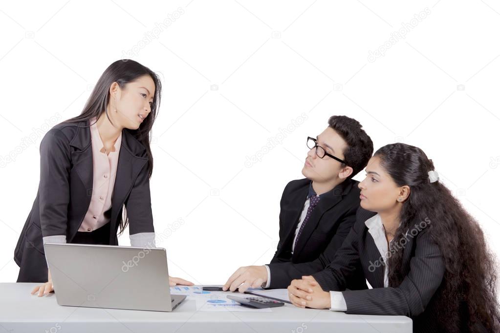 Japanese business manager talks to her staff
