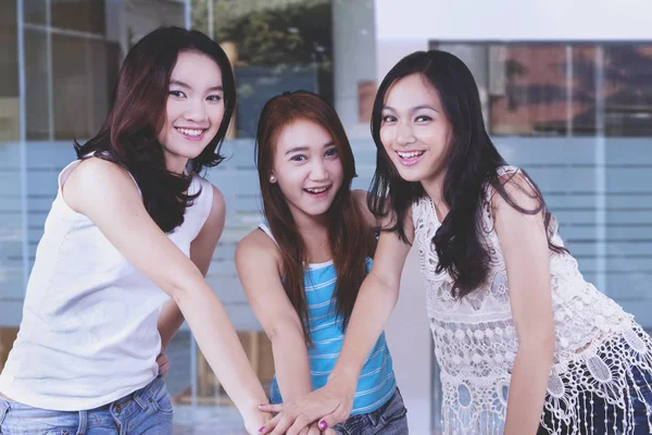 Group of teenagers high five showing team work hand gestures — Stock Photo, Image