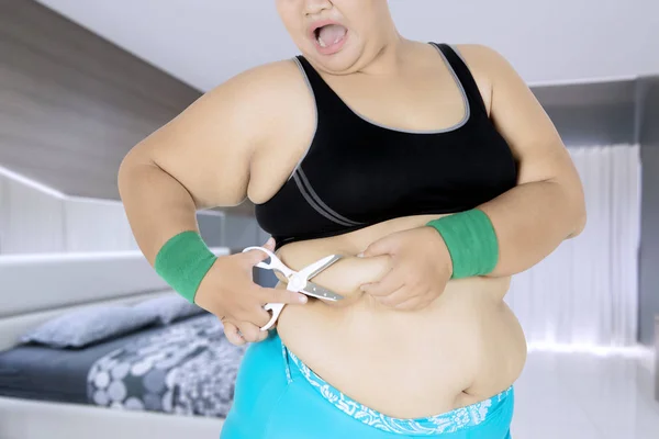 Overweight woman Cut belly fat and cellulite by scissors — Stock Photo, Image